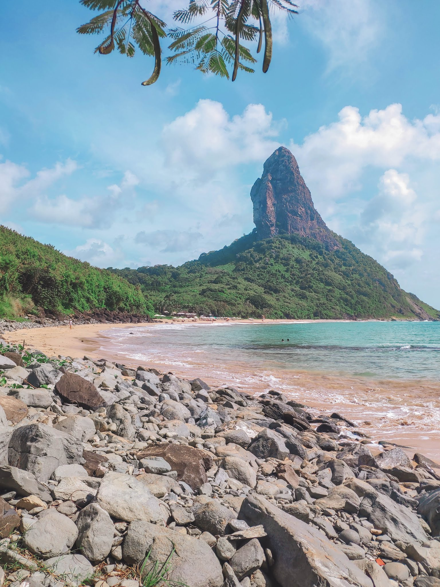 Guide to Fernando de Noronha Beaches - Praia da Conceição and Morro do Pico in the background